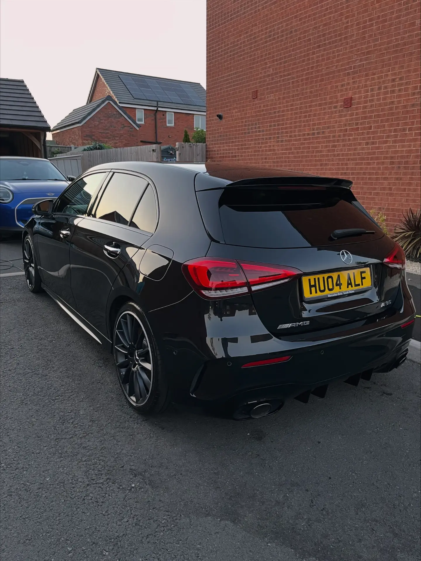 Rear three quarter view of a Mercedes AMG after an exterior wash
