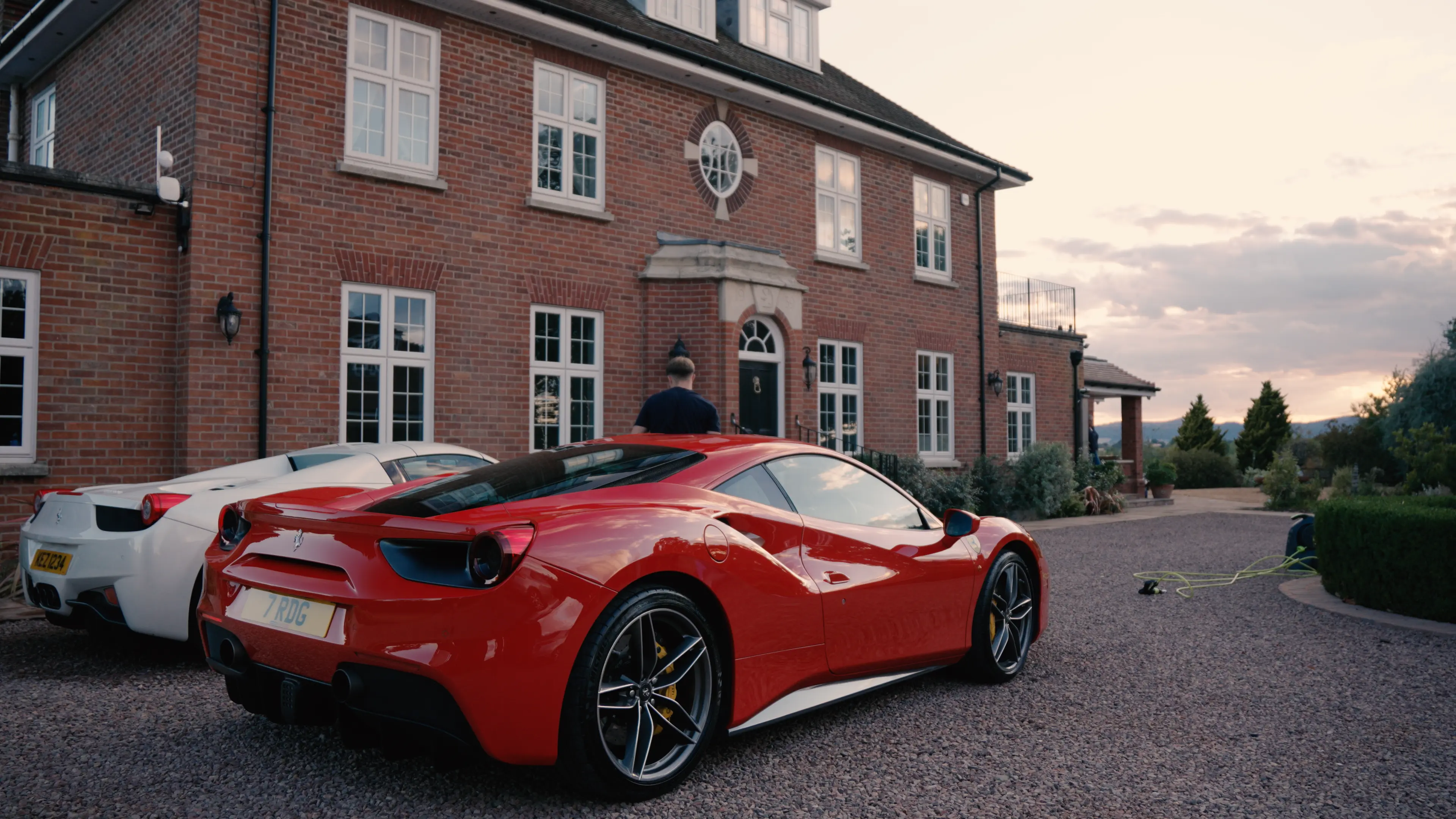 Red and white Ferraris parked outside after detailing at sunset